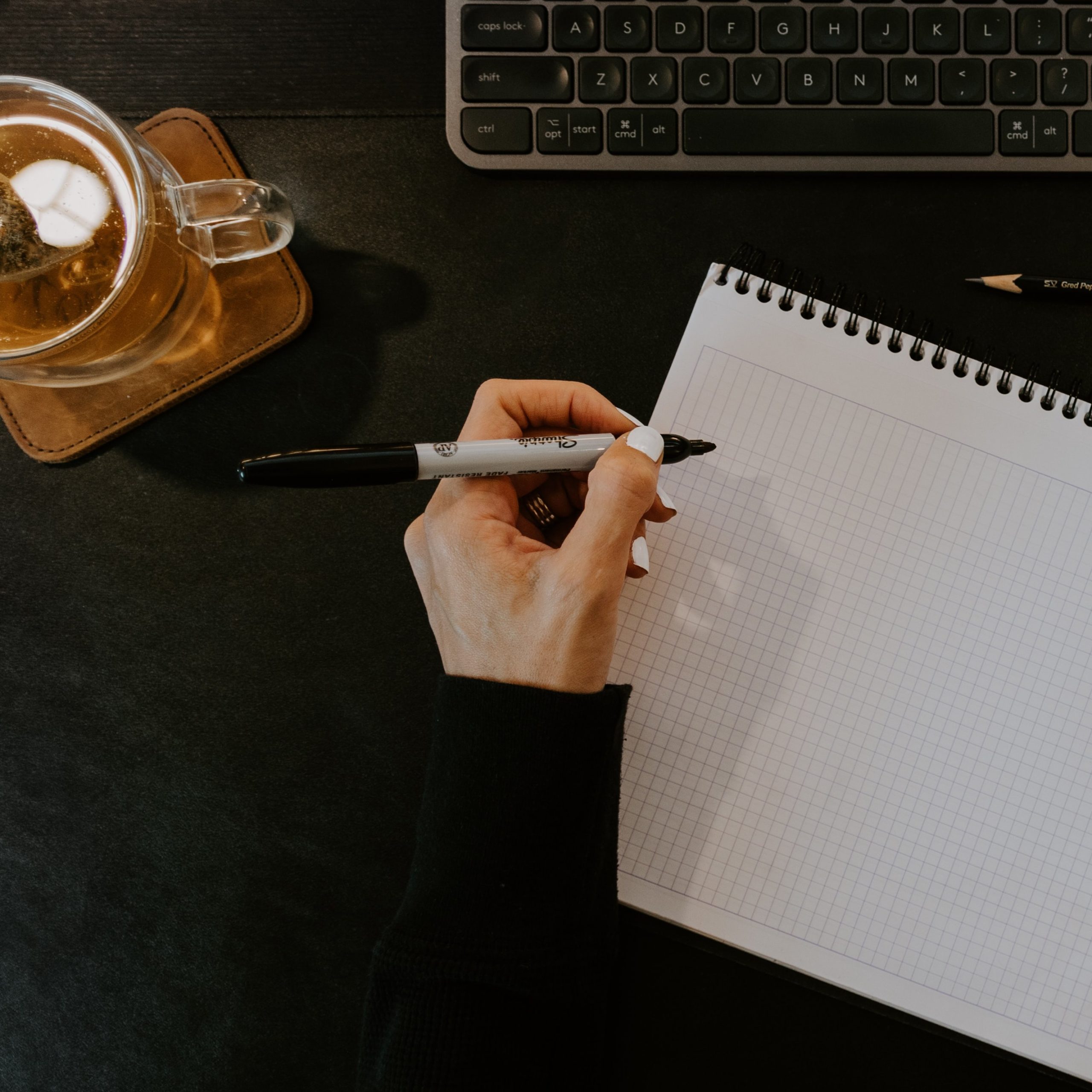 Person writing on a piece of paper