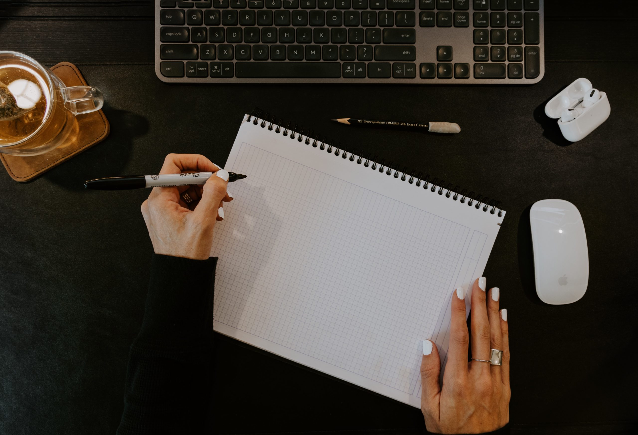 person writing on piece of paper