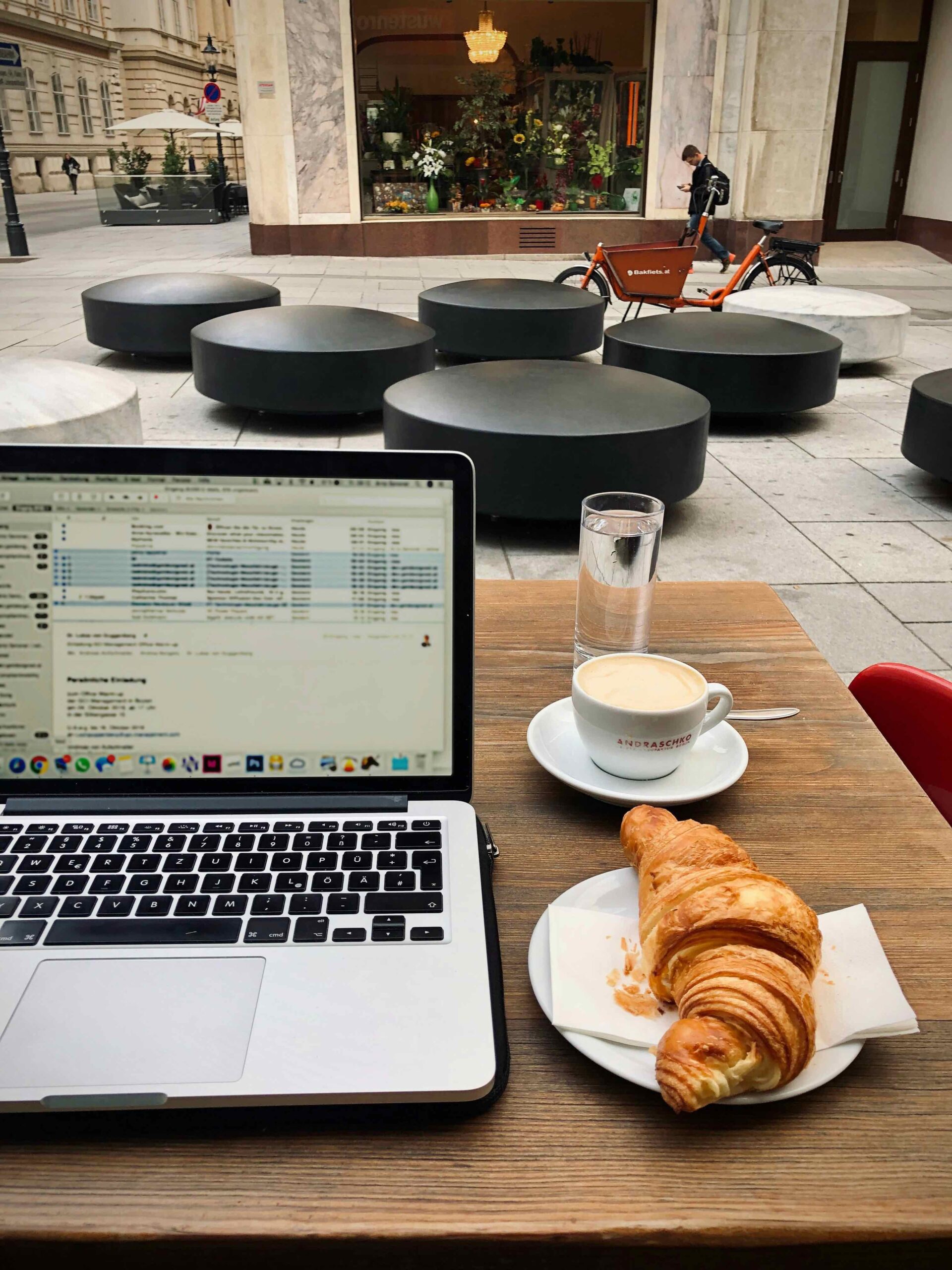 Woman on laptop at a cafe